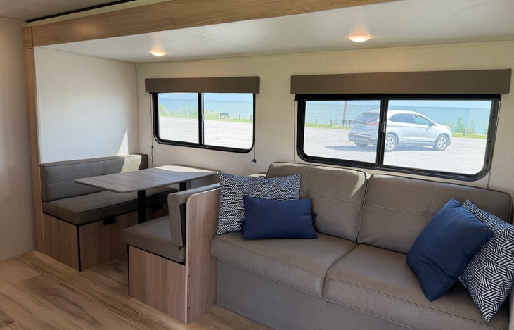 Cozy up for movie night on the plush sofa, which doubles as an extra sleeping spot for guests."