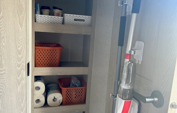 Large pantry/closet. Comes with 2 rolls of paper towels, mops, broom, travel vacuum and plenty of storage needed. Along with a basket for all those shoes too!