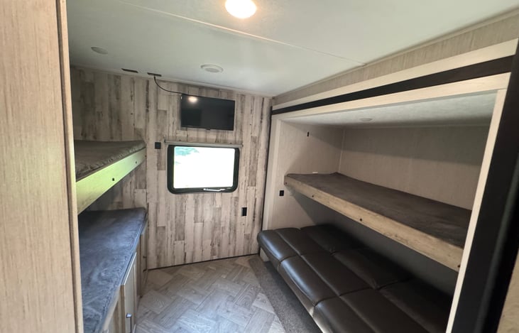Bunkhouse showcasing all beds set up. Additional storage accessible under bunk.