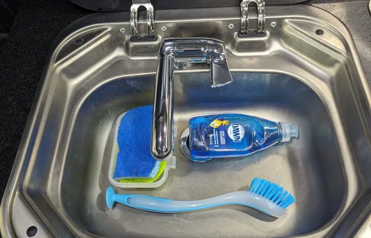 I include dish soap and sponge and scrubbing brush as well as a collapsible sink for doing dishes outside