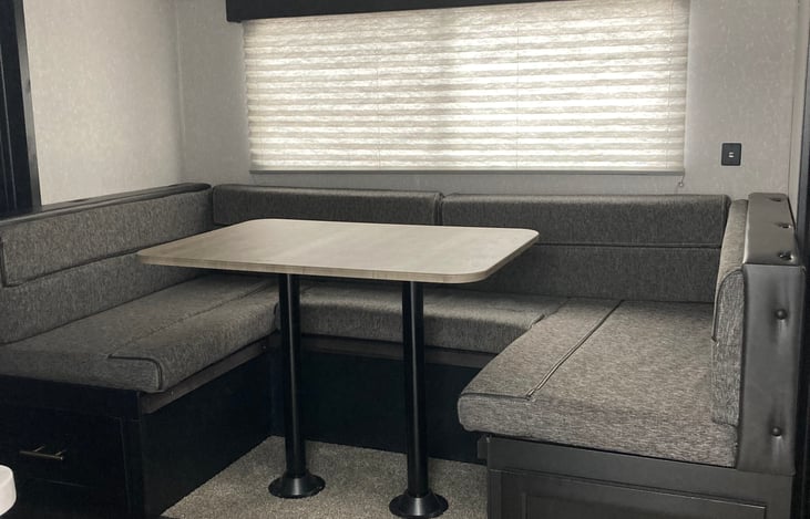 Jake offers comfortable seating for 6 people. When the sun goes down, this pop out dining area  transforms into a bed that sleeps 2.