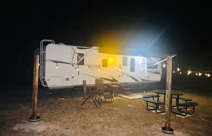 A peaceful nighttime setting that feels private, cozy, and welcoming after dark.