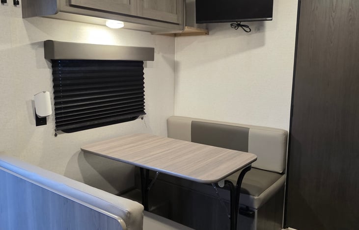 Dining table with ample pantry storage above. Dining table converts to a single bed.