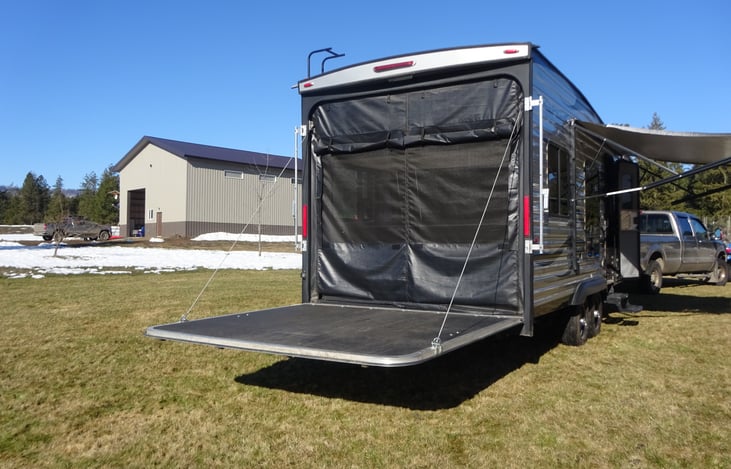 Rear cargo door as a pation with netting in place to keep bugs out.