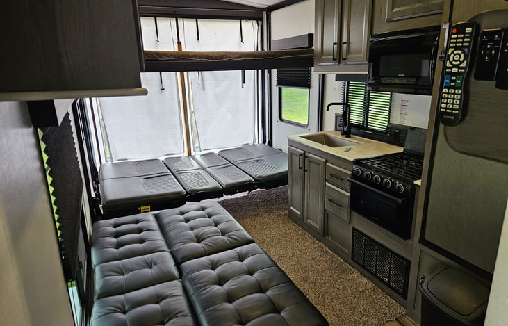 Drop the Happy Jack beds down from the ceiling and Layout the Futon for comfortable sleeping for 4 adults. The top Happy Jack bed can hold 2 small kids or 1 smaller sized adult. 250lb limit please :)