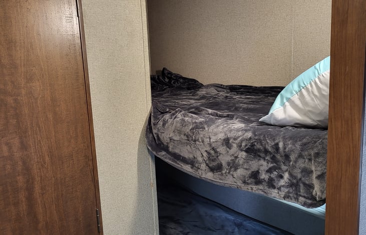 2 bunks by bathroom, across from kitchen area.