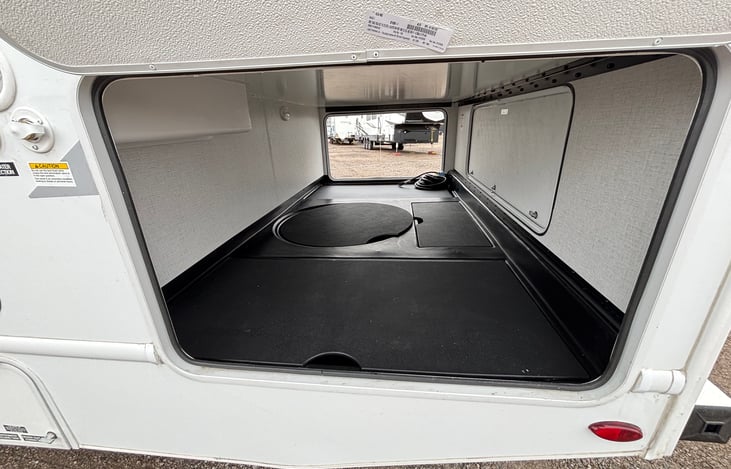 Pass through exterior storage with table and ice ben