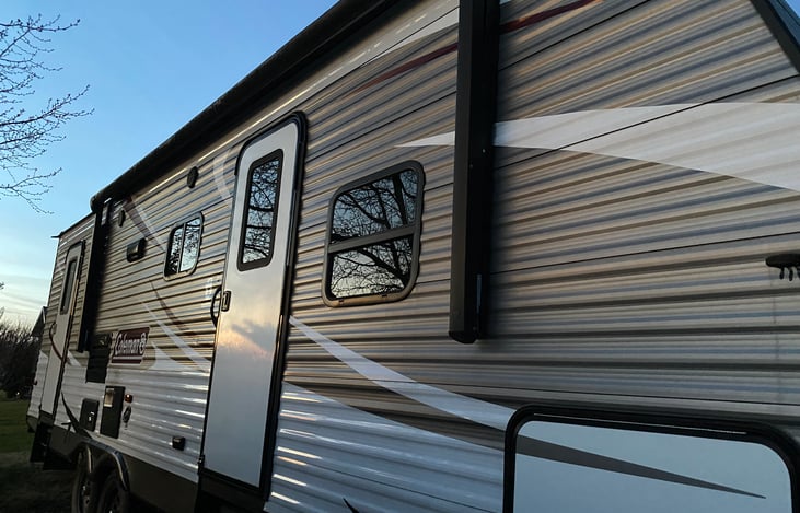 Front door and bathroom door in the rear of camper.
