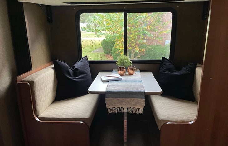 The top bunk drops down, the table converts to a bunk, and there is a snap-on curtain.