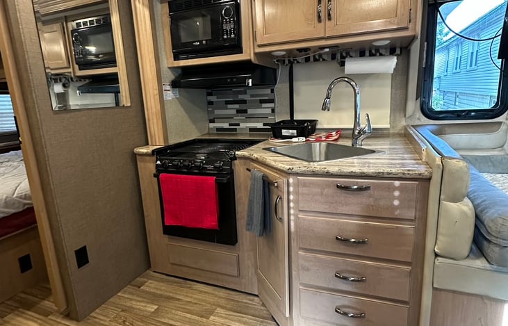 Comes with plates, bowls, cups, mugs, silverware, cooking utensils, and some pots and pans