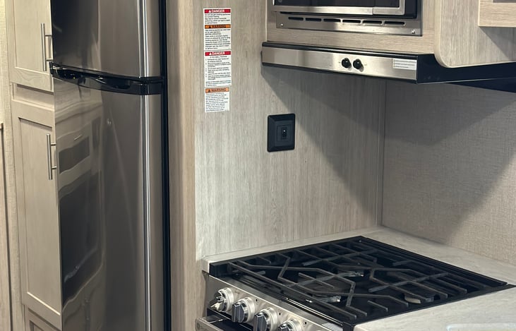 Kitchen with microwave and range top stove
