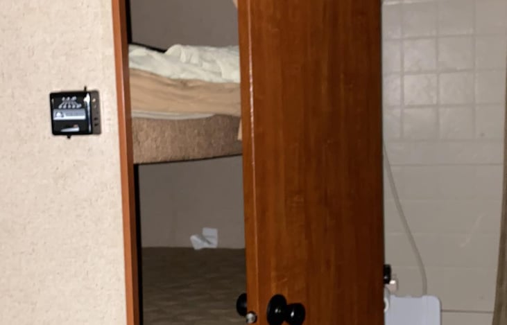 view from kithen area to bathroom and bunks