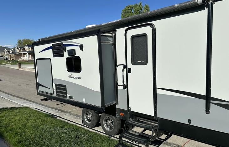 Slide out opens up the living area and also houses an outside extra refrigerator and TV for hosting a game night or just convenient access to those cold drinks or snacks.