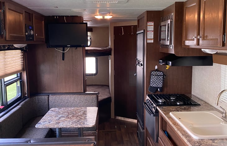 2 bunk beds that can easily fit 2 kids.  Bathroom has a bathtub and shower.  The water heater heats by gas or electric.