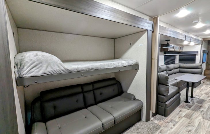 Fold-down bunk over rear couch, which folds into another bed