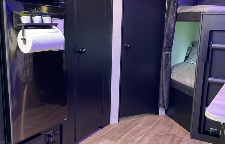 Paper towel holder mounted on the fridge door.