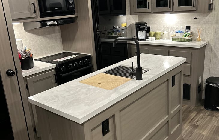 Well-equipped kitchen with large sink, island and counters galore.
