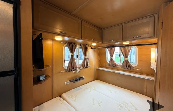 TV is mounted above the bed.