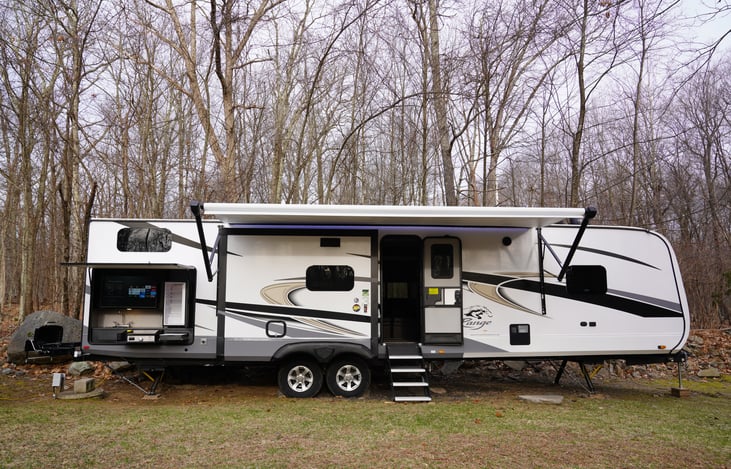 Large awning with LED lighting. Solid step stairs. (won't rock the camper when coming in and out)