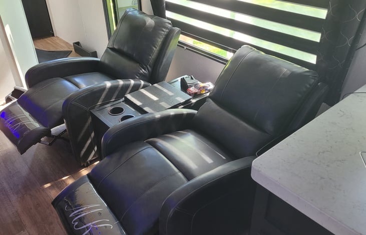 Two recliners with a table between make relaxing easy. They're made of the same material as the sofa and very comfortable.