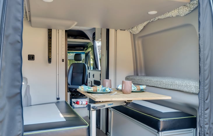 UPGRADE! additional table that is height adjustable and bench seating. Storag for benches can be accessed through both the top and end of the rear doors.