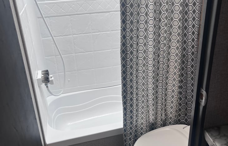 Tub/Shower with toilet in the same space.