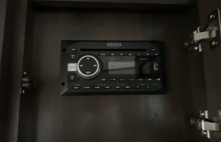 Jensen Media control system has alarm clock, AM/FM radio, two different zones, DVD player, USB media player, connects via bluetooth to your phone.