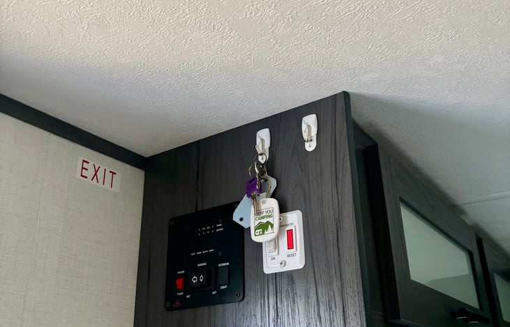 control panel with key hangers and smoke alarm