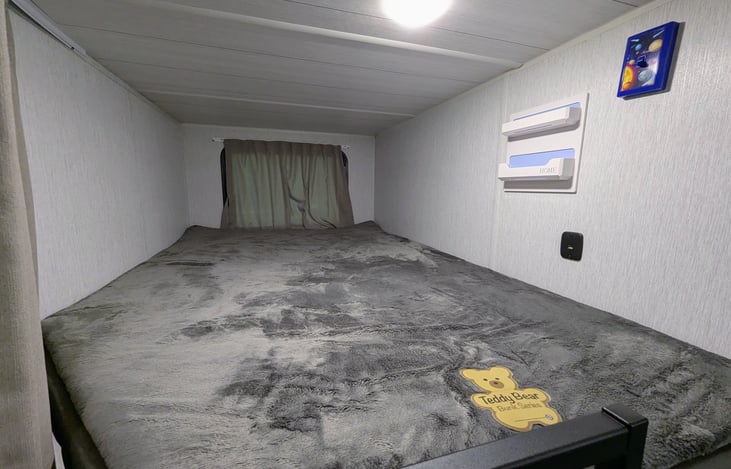 Large Twin-XL bunks with USB charging ports and window.