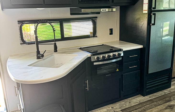 Kitchen and Fridge. Equipped with a standard RV size microwave, stove and oven