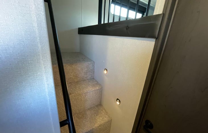 Steps up to an overhead bedroom.
