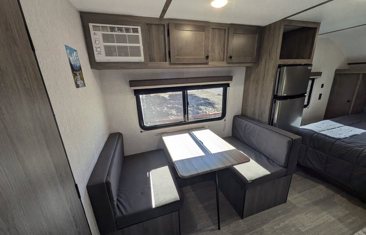 Wall unit air conditioner, dinette, solar-powered fridge and plenty of storage