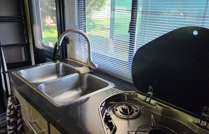 Full gas burner stovetop, with two well sink.