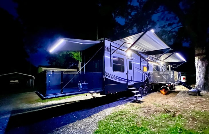 Dual Outdoor Patios – Enjoy two separate patio spaces! The main side patio features its own TV for outdoor movie nights and game days. The rear patio connects to the versatile garage space.