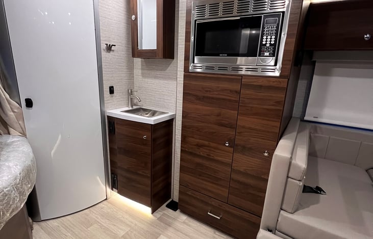 Sink outside bathroom so someone can use while others in bathroom.