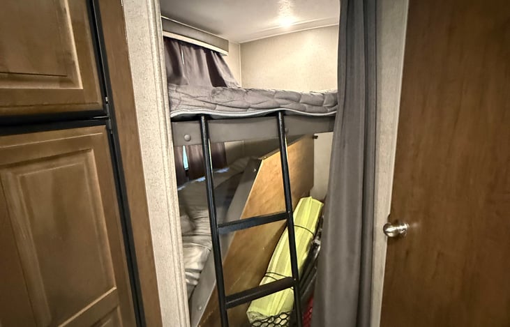 Bottom bunk folds up for storage while traveling.