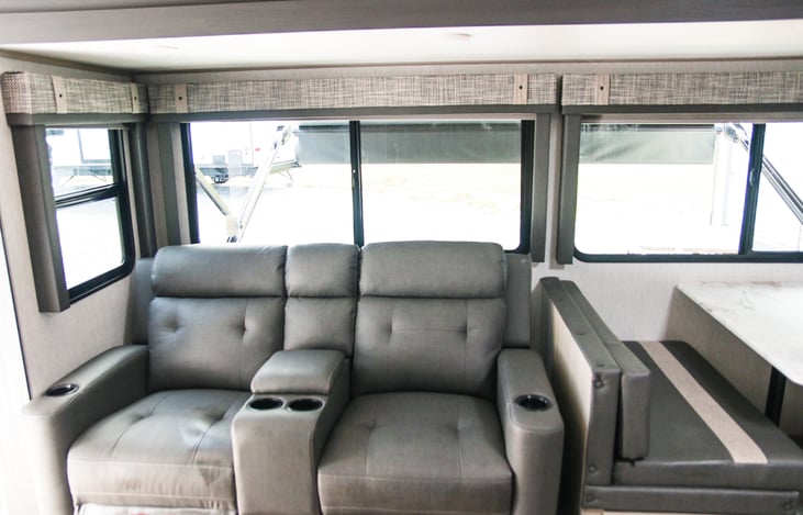 Comfortable recliners with lighted cup holders.