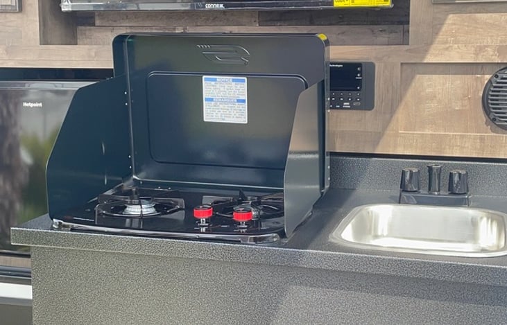 outdoor kitchen with built in TV and surround sound