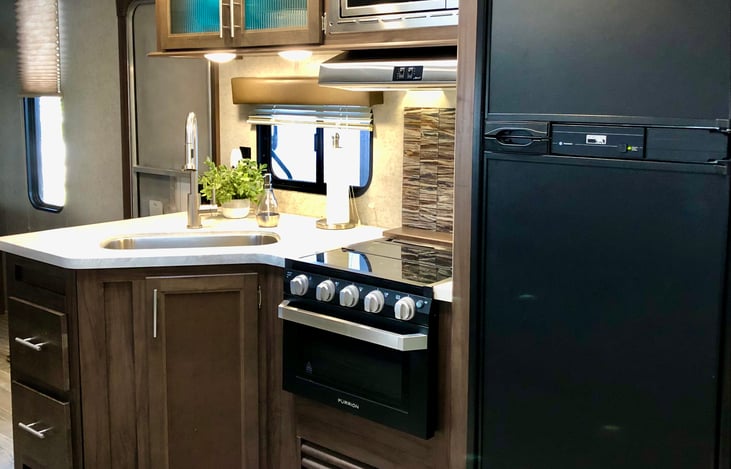 Fully stocked kitchen with gas stove and oven, microwave, dishes, pots and pans, coffee maker, popcorn maker, etc. etc.