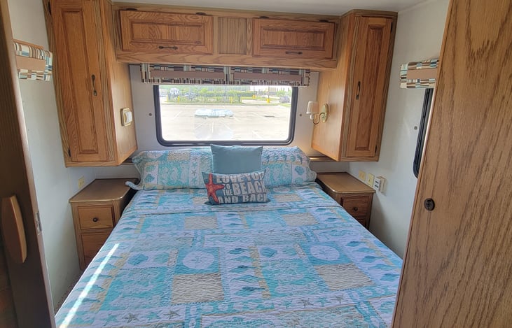 Private bedroom with accordion door, queen bed