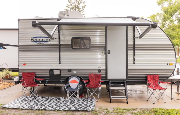 Outdoor rug, chairs, and table is provided