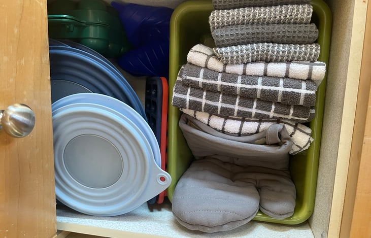 Kitchen Towels, pot holders and assorted storage containers