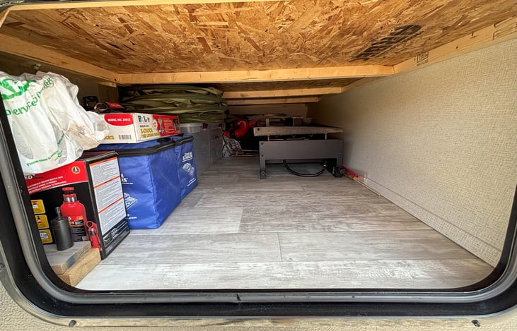 Front Pass-thru Storage (Blackstone, Outdoor Rugs, pop-up trash cans, all included and stored here)