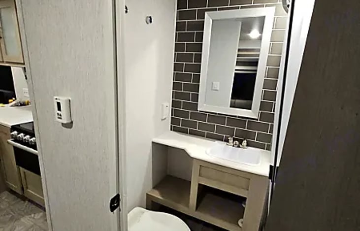 Bathroom mirror, vanity and storage shelves