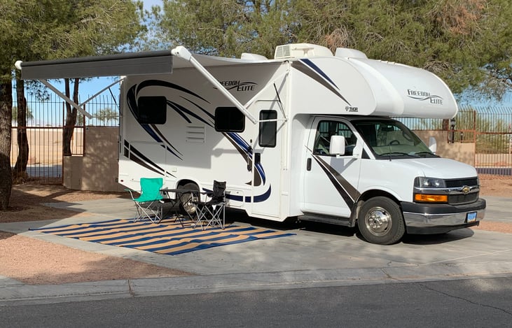 Electrical awning with LED lights, an outdoor rug, and a windshield privacy cover included.