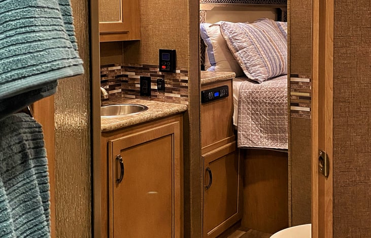 Tha pass-through bathroom allows easy access from the master bedroom or the main cabin area for privacy and convenience.