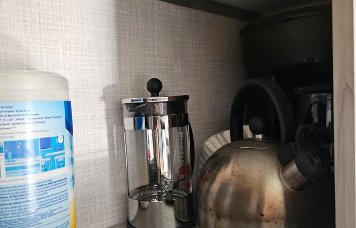 Cabinet above dinette with kettle, french press and coffee maker (requires hook up or generator)