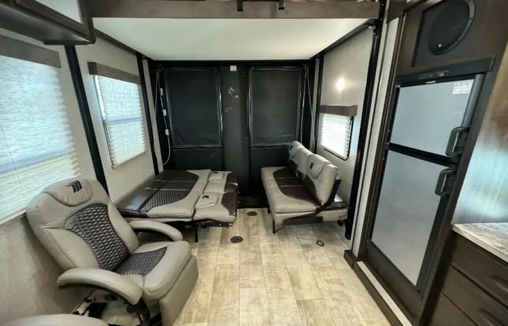 Convertible rear area. Storage of your toys. Install the table for your dining room, stow the table away for couches, and lastly flatten the couches and lower the upper bed for 2x queen bed sleeping