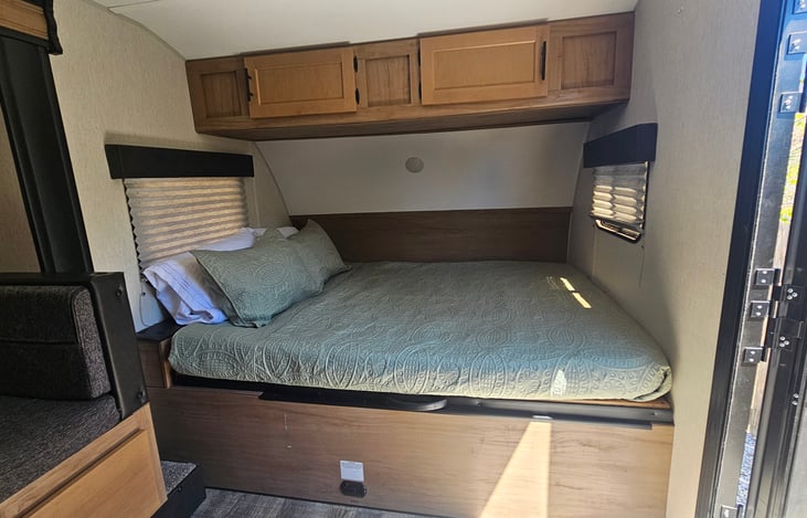 Queen Bed comes with pillows, comforter, flat sheet and fitted sheet. Bed lifts to access storage underneath.
Storage above has extra items and bedding as well as card games and board games.