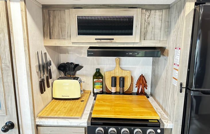 Toaster, quality cutting knifes, stove top and small oven for use during rainy days.  The outside kitchen dwarfs this space so rarely do guests fire this up :)